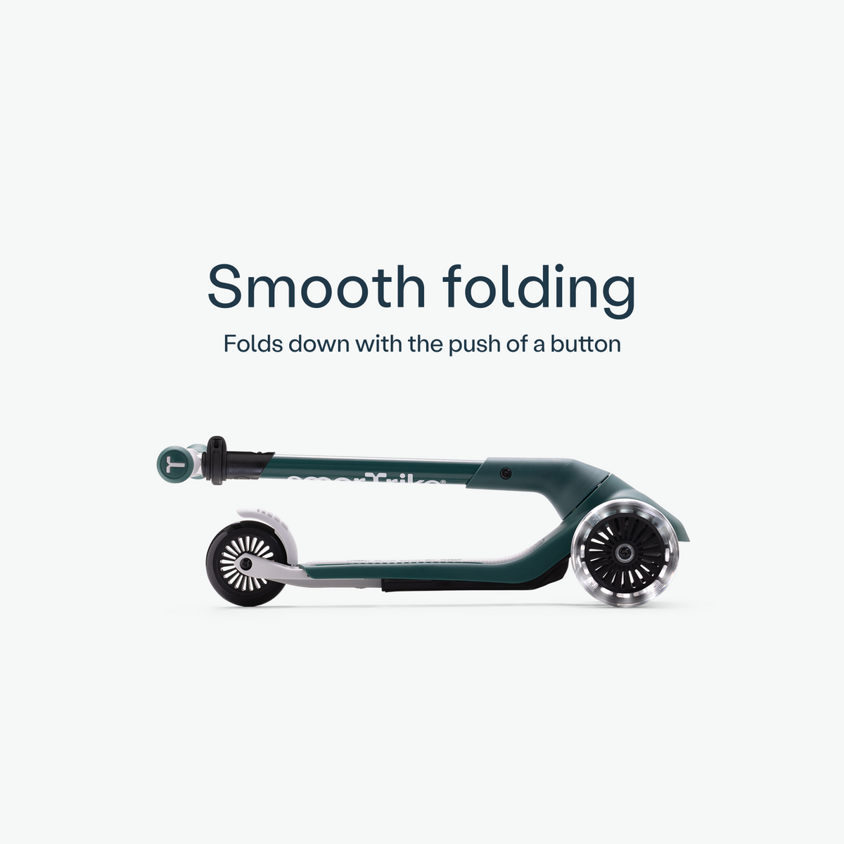 Green smarTrike Xtend Mini+ scooter folded for compact storage, showing its lightweight and portable design.
