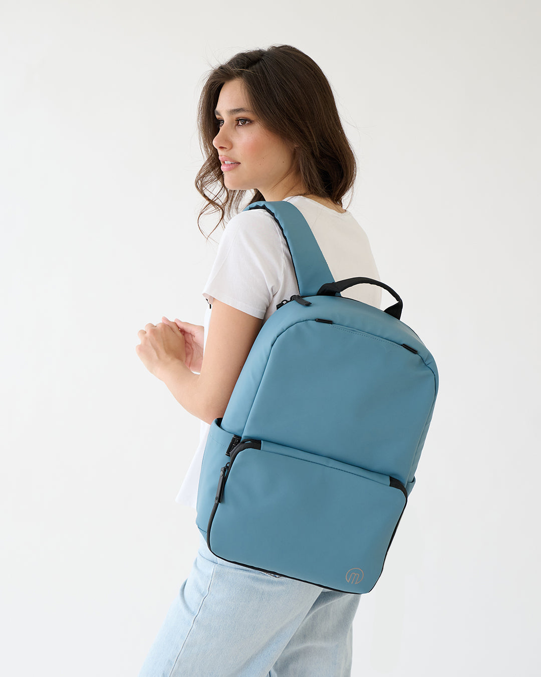 MiaMily expandable backpack in slate blue with multiple compartments and adjustable straps, suitable for travel and daily use.