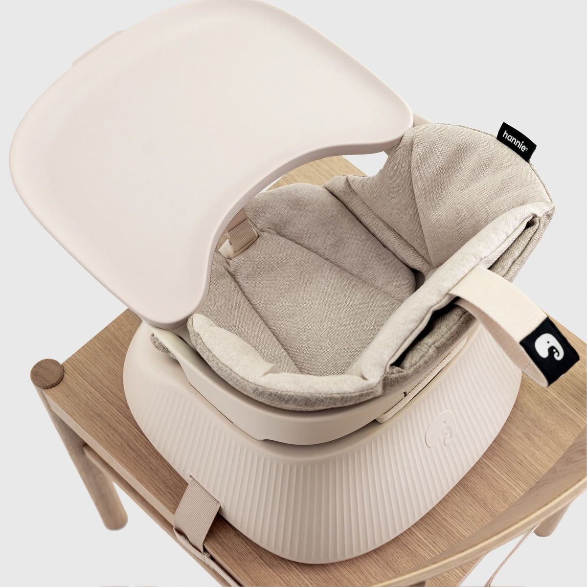 Hannie portable high chair in white sand color with a sleek design and sturdy frame, suitable for indoor and outdoor use.