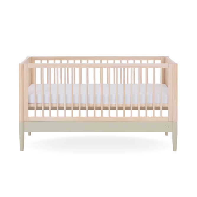 Eos Cot Bed in natural ash finish with desert sage accents, sturdy wooden frame, and slatted sides for baby sleep safety.
