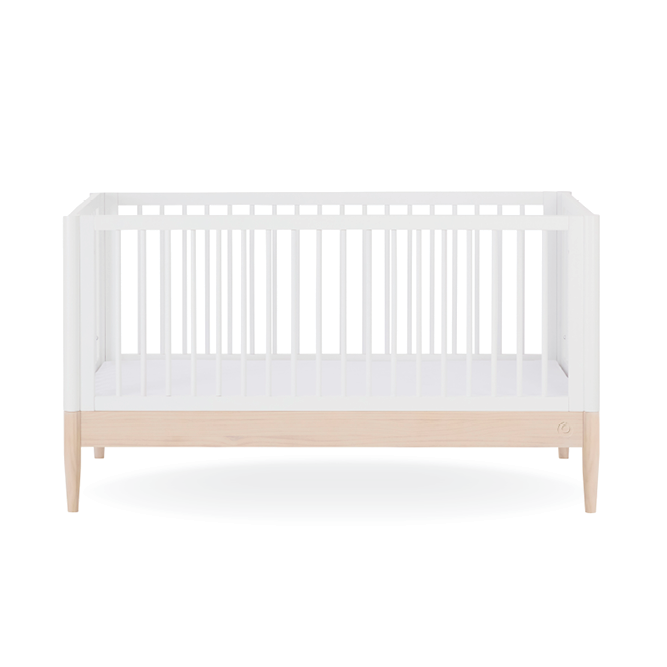 White Gaia Baby Eos Cot Bed with natural ash accents, showcasing a sturdy wooden frame and sleek modern design.