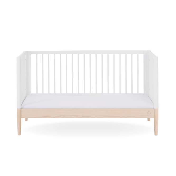 White Gaia Baby Eos Cot Bed with natural ash accents, featuring a sturdy frame and sleek design for a modern nursery.