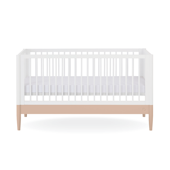 White Gaia Baby Eos Cot Bed with powder blush accents, featuring a sturdy frame and classic design for a safe nursery centerpiece.