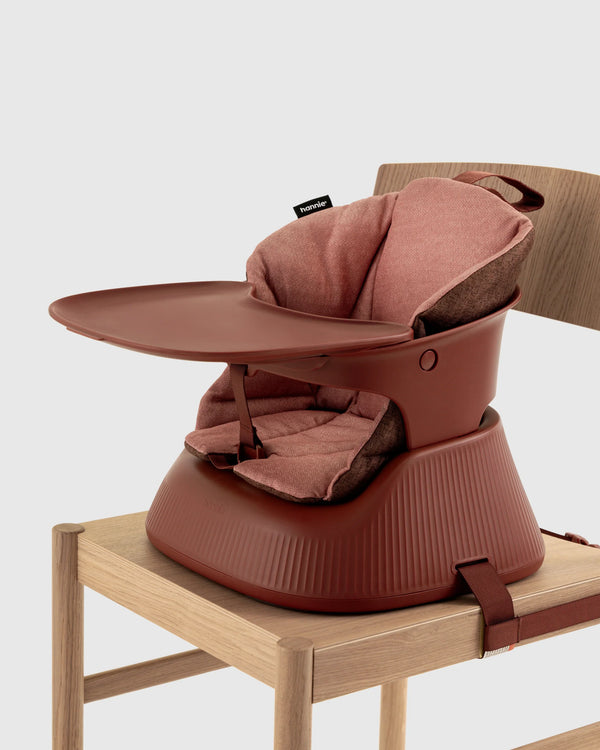 Hannie portable high chair in mahogany red with a sturdy frame and comfortable seat, perfect for feeding on the go.