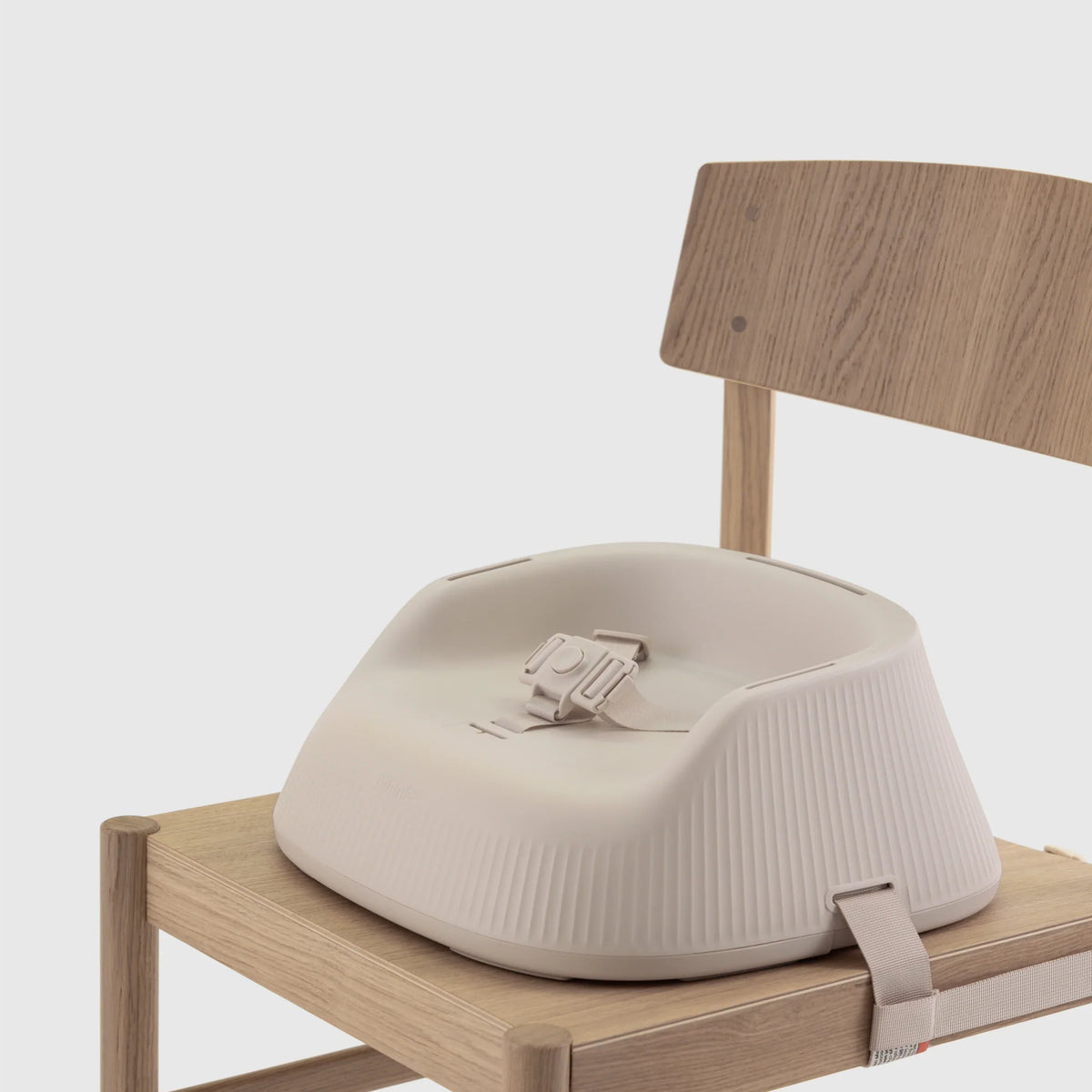 Hannie Portable High Chair in White Sand color with a comfortable seat, designed for easy portability and family dining.
