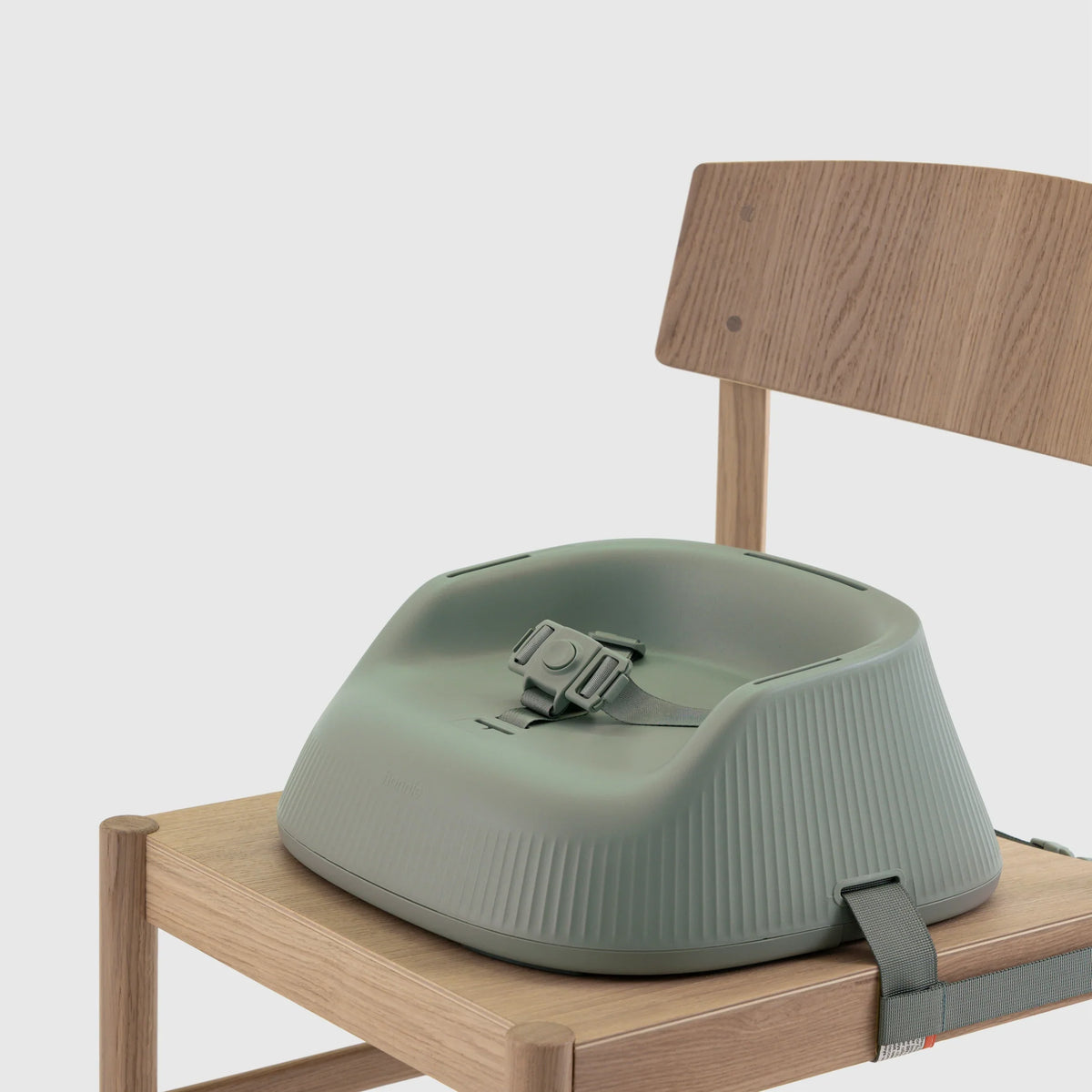 Hannie portable high chair in sage green with a sleek design and adjustable tray, ideal for feeding and seating young children.