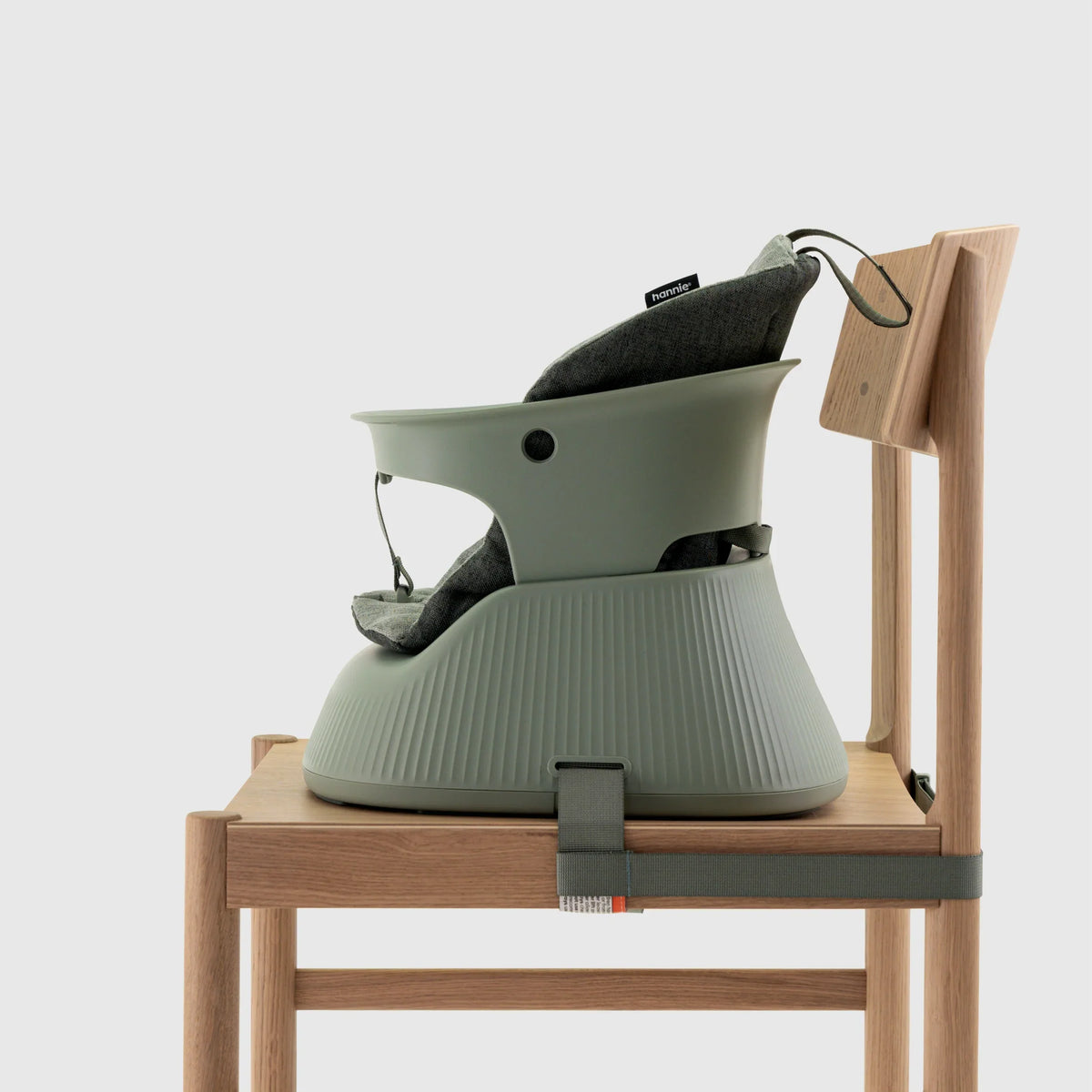 Hannie Portable High Chair in sage green with padded seat and side view, designed for comfortable feeding and easy portability.