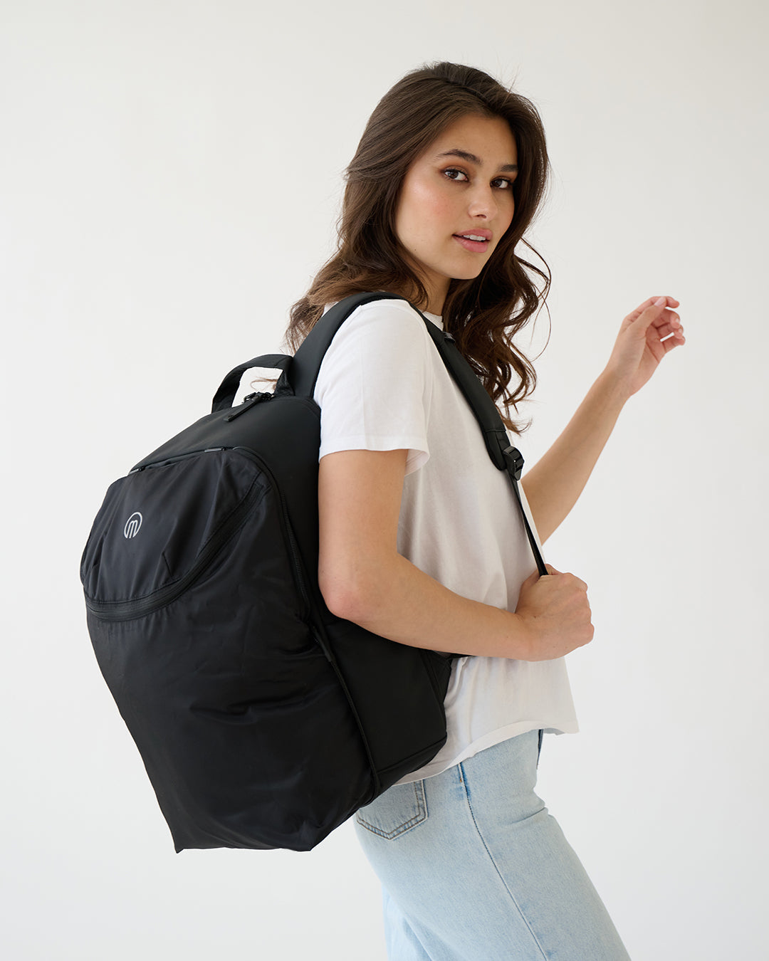 MiaMily expandable backpack in midnight black with multiple compartments, showing a sleek, versatile design for travel and daily use.