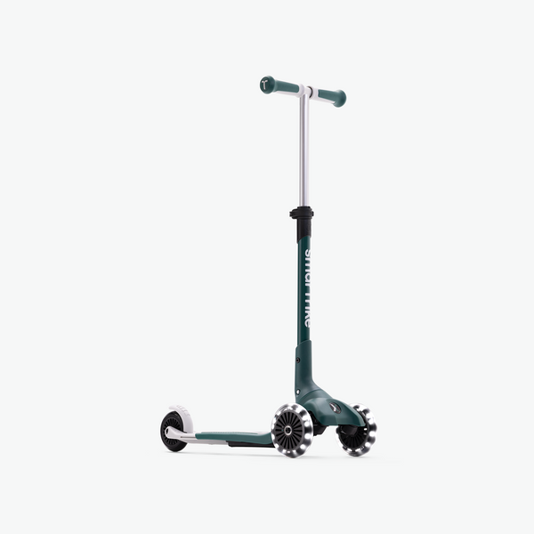 Green smarTrike Xtend Mini+ scooter with front view, compact design, and sturdy handlebar for kids' outdoor riding.
