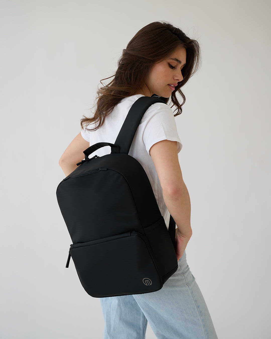 MiaMily expandable backpack in midnight black, showing a sleek, versatile design with multiple compartments and adjustable straps.