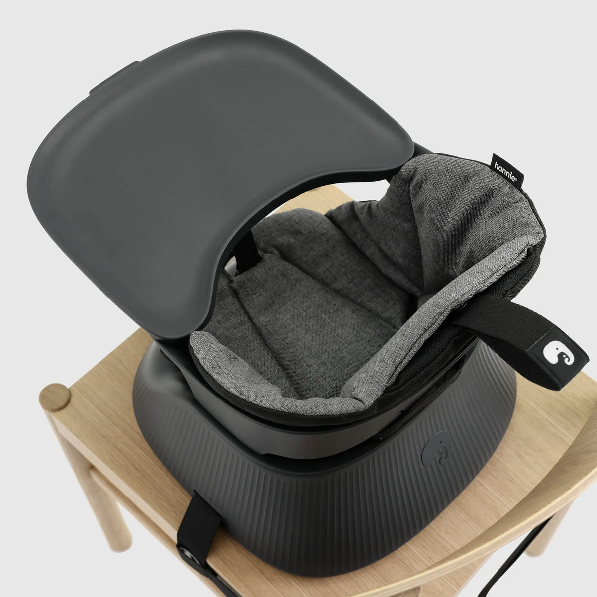 Hannie portable high chair in charcoal black with detailed close-up view, showcasing durable material and sleek design.