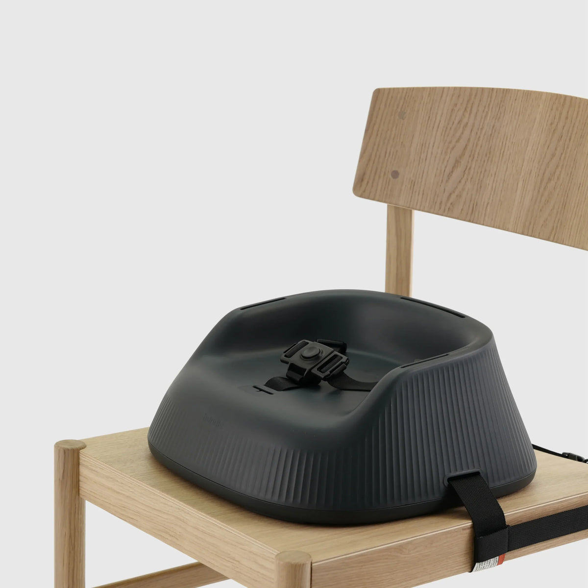 Hannie portable high chair in charcoal black with a black seat, designed for easy seating and convenience.