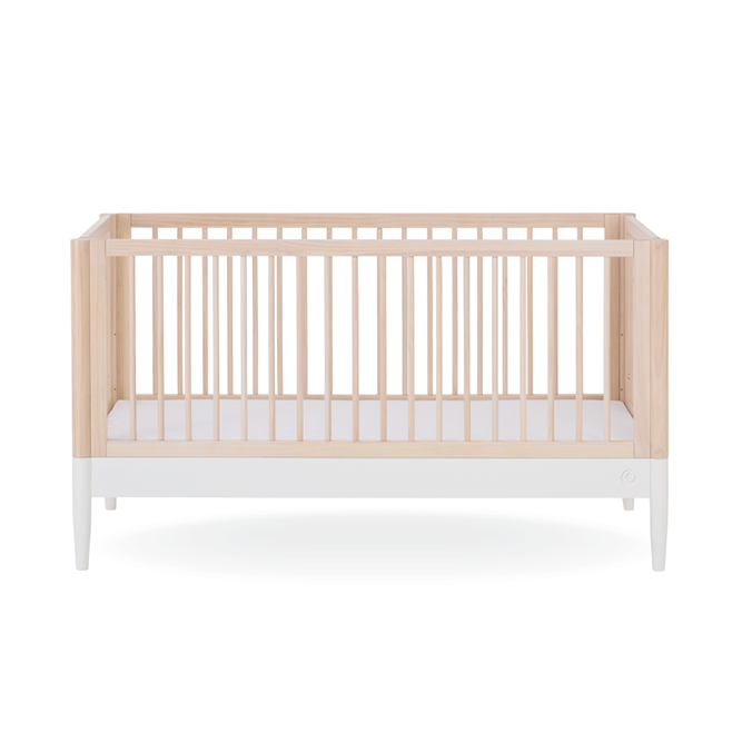 Gaia Baby Eos Cot Bed in natural ash finish with white accents, showcasing its sturdy wooden frame and sleek modern design.