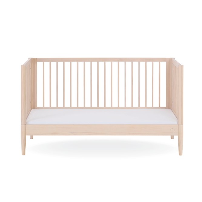 Natural ash Gaia Baby Eos Cot Bed with slatted sides and sturdy frame, designed for a safe and stylish nursery space.