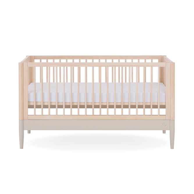 Eos Cot Bed in natural ash finish with soft cashmere bedding by Gaia Baby, showing the wooden frame and bedding details.