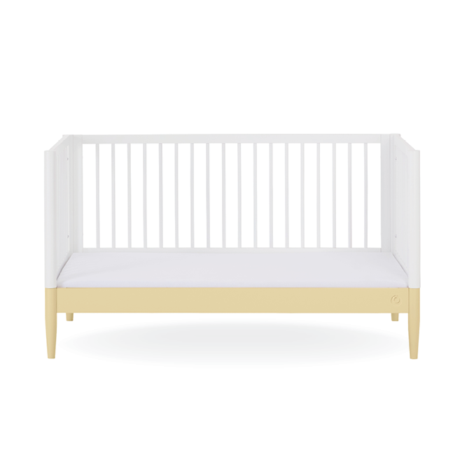White Gaia Baby Eos Cot Bed with Primrose Yellow accents, showcasing the sturdy wooden frame and classic design.