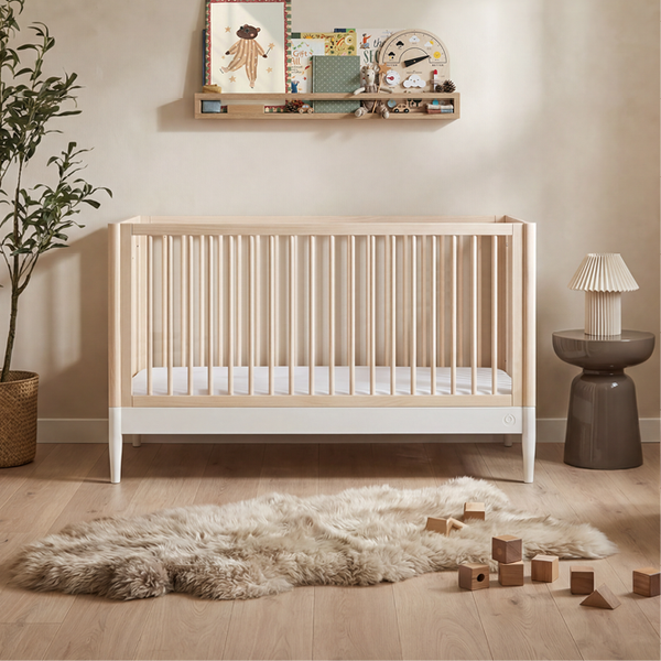 Gaia Baby Eos cot bed in natural and white wood finish, sturdy toddler bed with safety rails and slatted sides for gentle sleep.