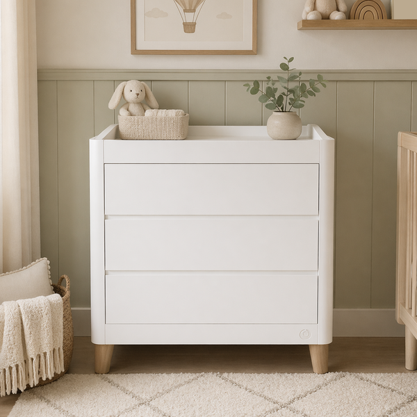 Gaia Baby Serena Dresser in white with natural wood accents, featuring multiple drawers for nursery storage.